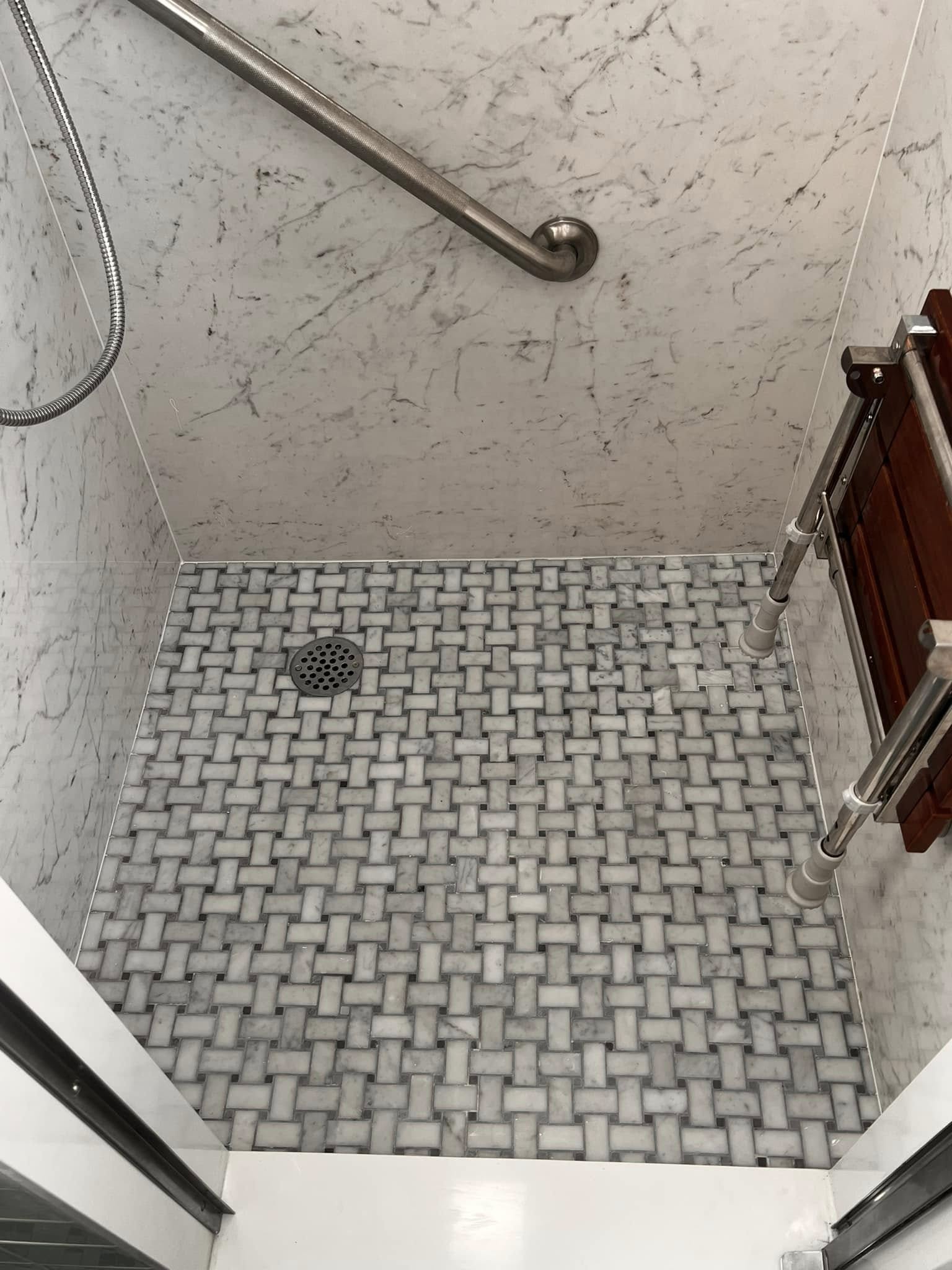 Detailed shower floor by Delaluz Construction