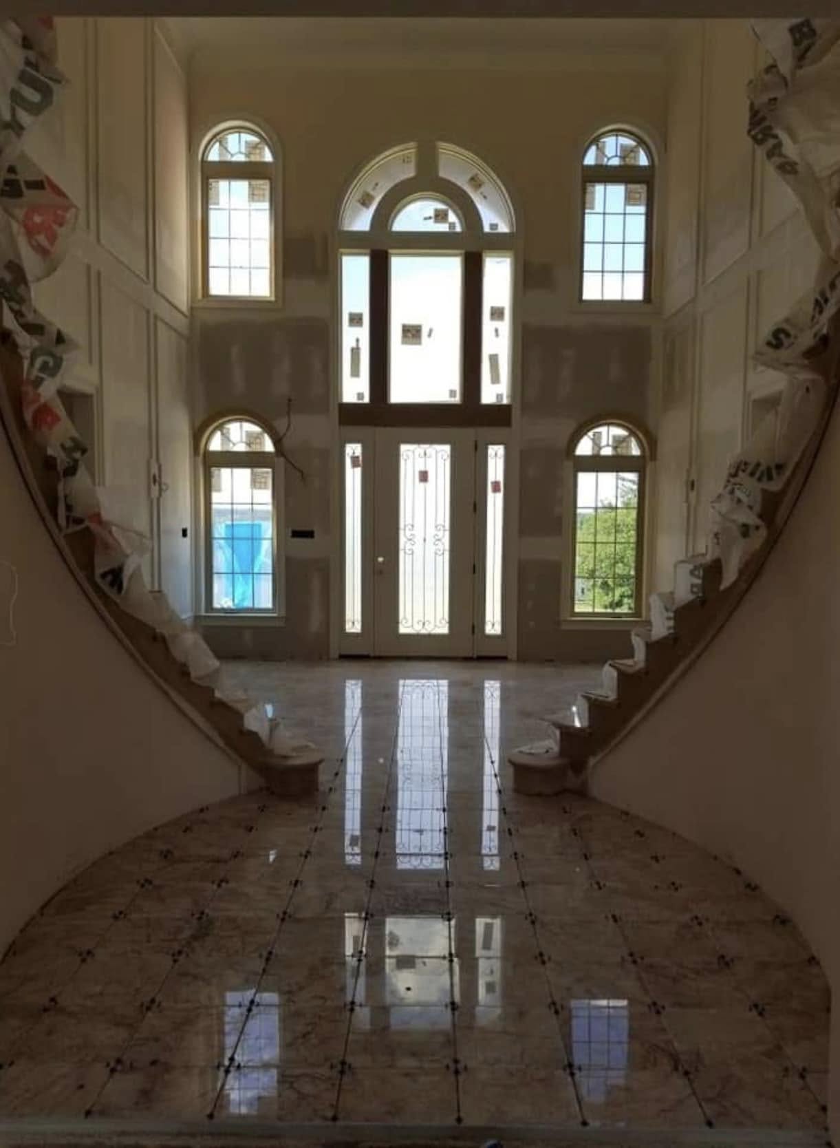 Grand foyer flooring by Delaluz Construction