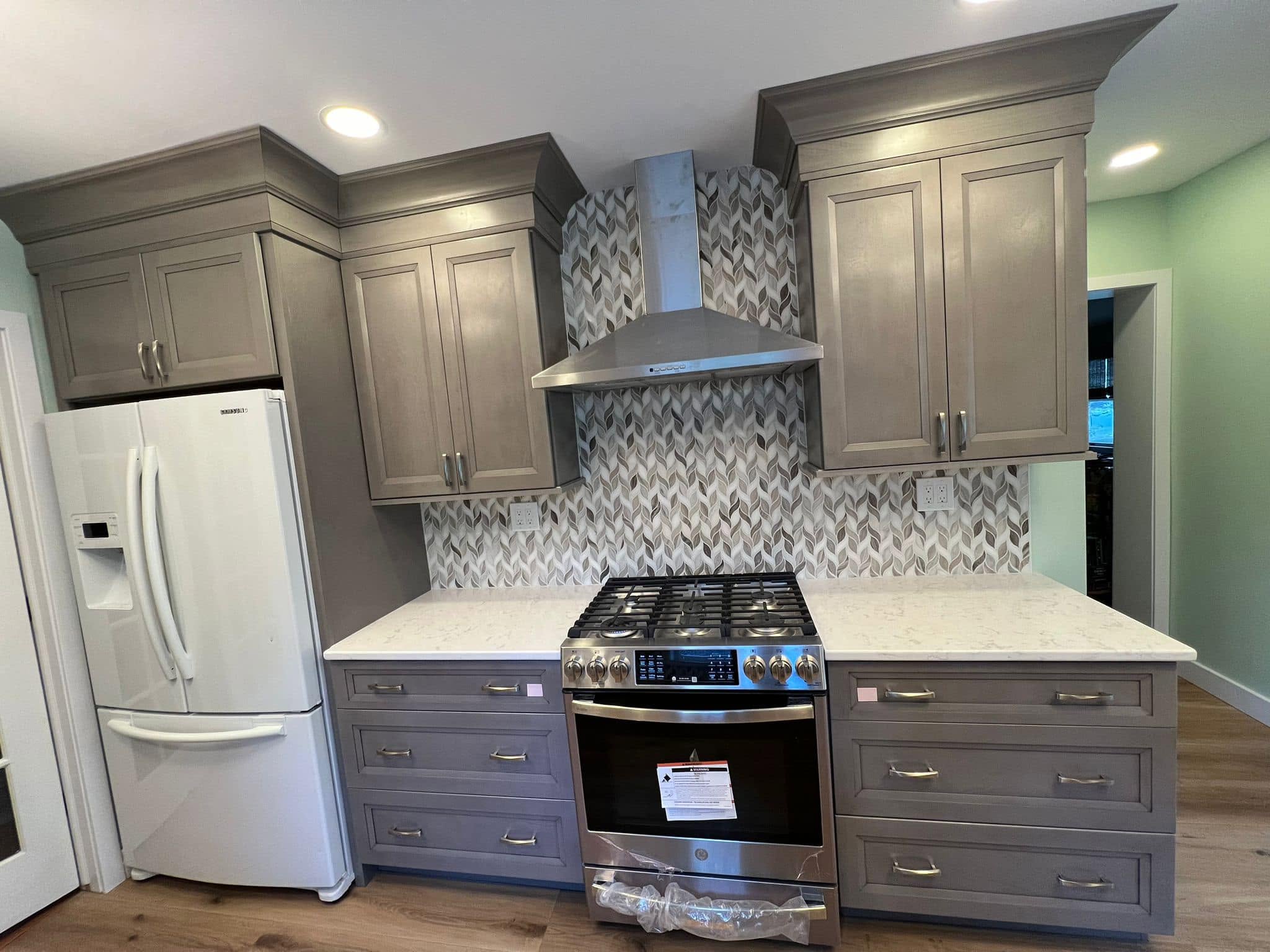 Complete gray kitchen renovation by Delaluz Construction